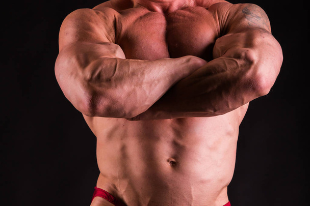 Bodybuilder posing in different poses demonstrating their muscle - Fotoğraf, Görsel