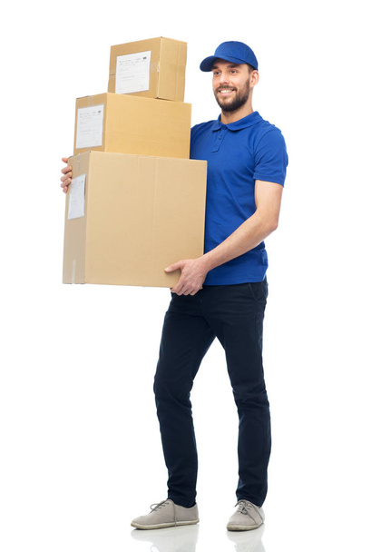 happy delivery man with parcel boxes - Фото, изображение