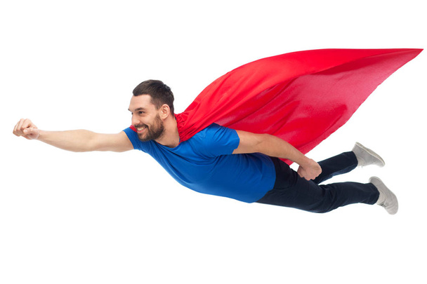 happy man in red superhero cape flying on air - Фото, зображення