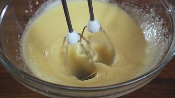 Electric mixer close-up view, whisk eggs with sugar for bisquit, slow motion - Footage, Video