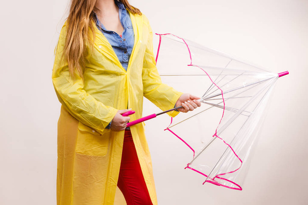 Woman wearing waterproof coat opening umbrella - Foto, imagen
