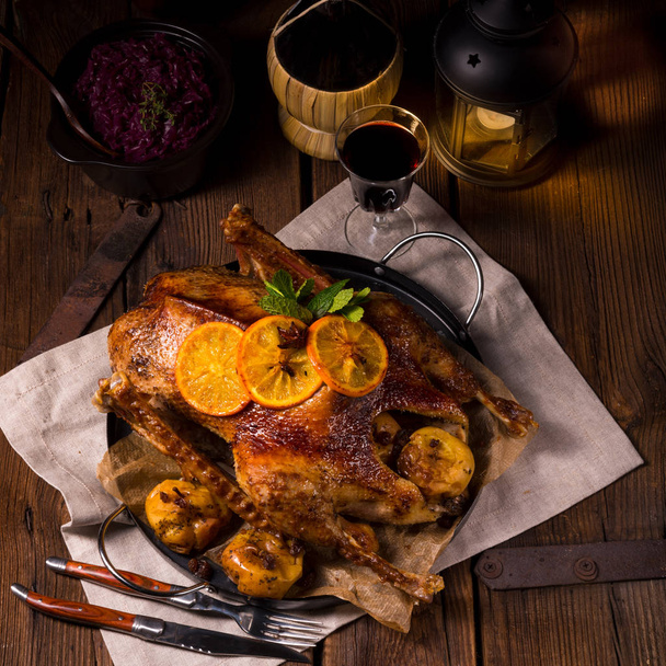 Crispy Roast goose with citrus on wooden table - Photo, Image