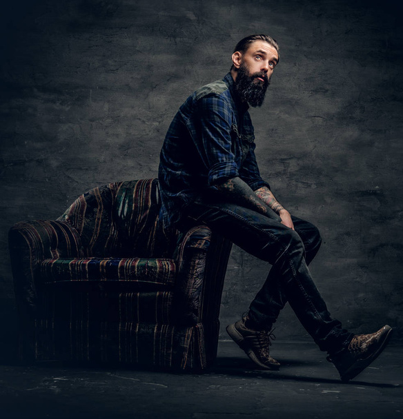 Bearded male sits on a chair - Photo, Image