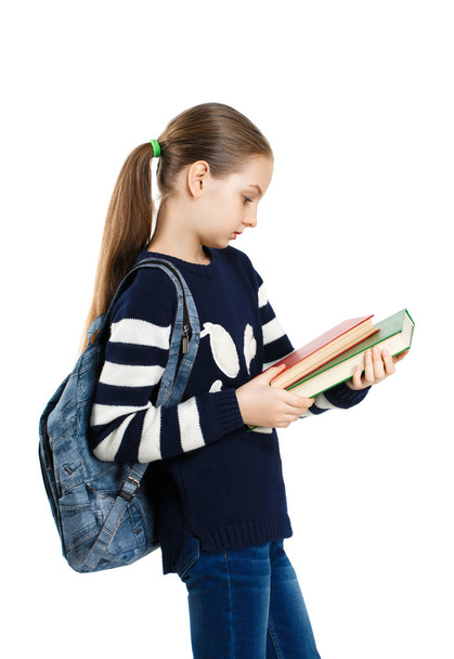girl schoolgirl with backpack and books. - Фото, зображення
