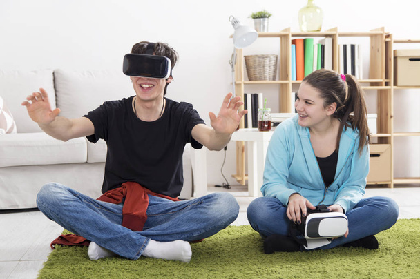 Boy and a Girl with VR glasses in living room - Fotografie, Obrázek