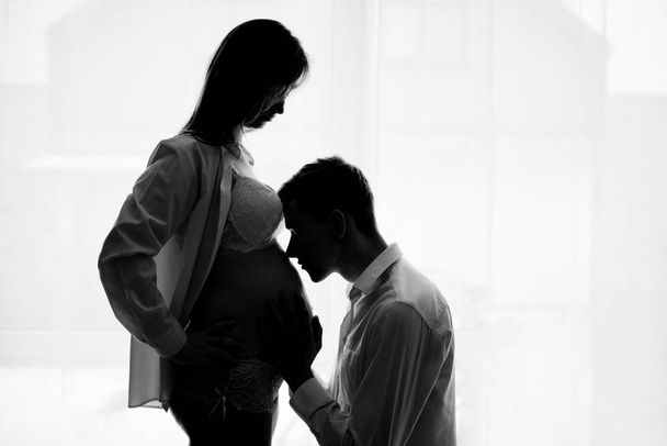 Husband is kissing pregnant wife's tummy - Fotó, kép