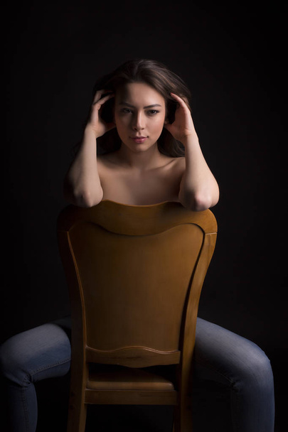 Glorious topless model with lush hair in the dark room - Fotó, kép