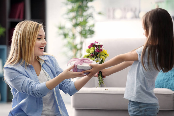 Little girl giving present to her mother at home. Mother's day concept - Fotoğraf, Görsel