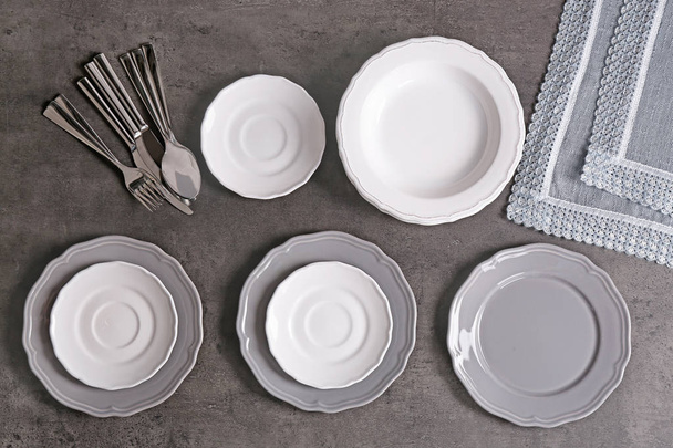 Empty dishes on grey   - 写真・画像