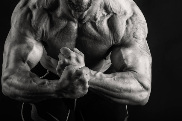 muscular male body on a black and white photo. - Φωτογραφία, εικόνα