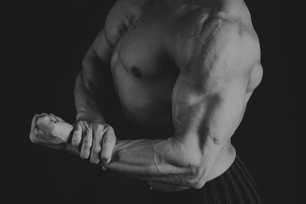 bodybuilder on a dark background. - Photo, Image