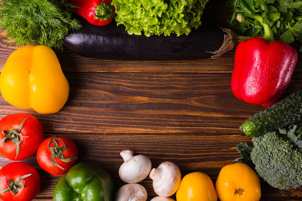 Different organic vegetables on a wooden background. Healthy eat - Valokuva, kuva