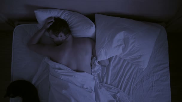 Insomnia concept. man in bed at night can not sleep - Filmmaterial, Video