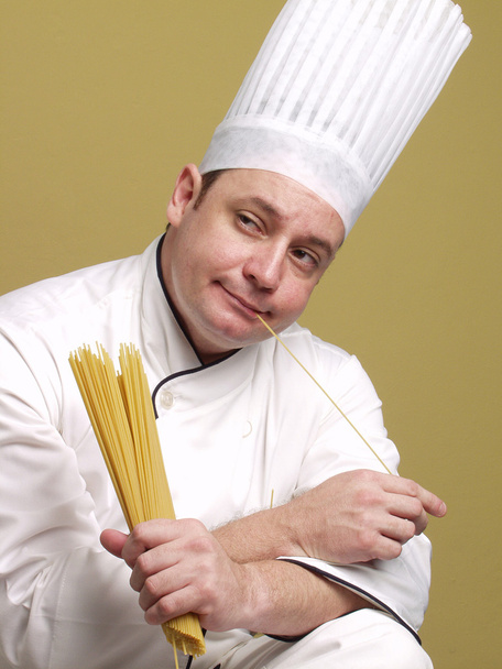 Young chef holding a pasta plate. - Fotografie, Obrázek