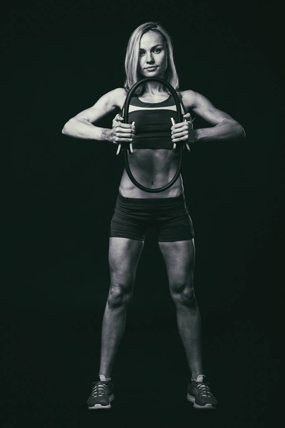 Luxury fitness girl on a dark background. - Foto, Imagem