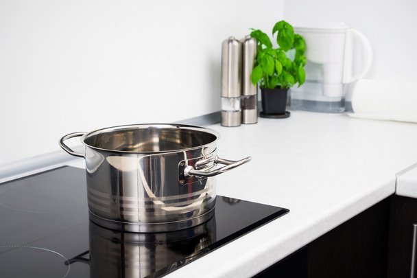 Pot in modern kitchen with induction stove - 写真・画像