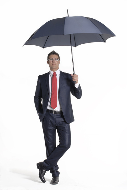 Young businessman holding an umbrella. - Foto, imagen