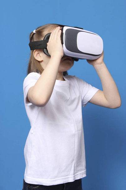 girl wore glasses virtual reality VR. isolated on blue background - Valokuva, kuva