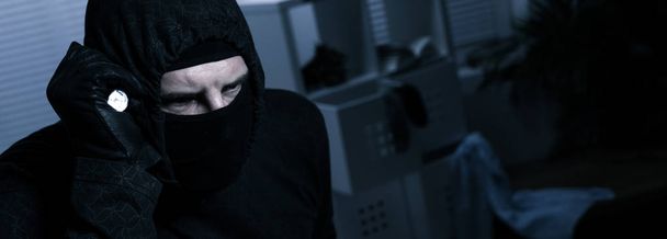 Masked burglar with flashlight - Foto, immagini
