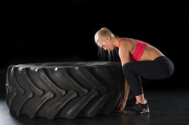 sporty woman with tire - Photo, Image