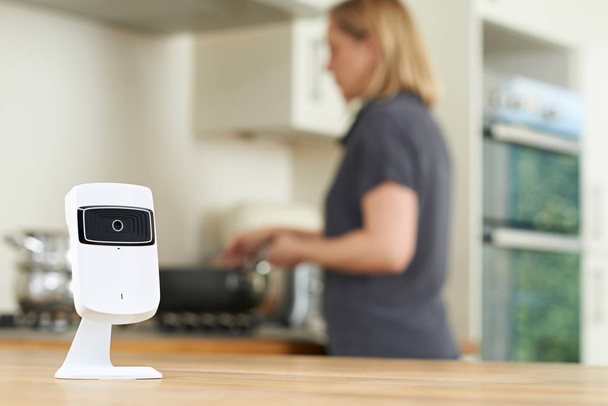 Smart Security Camera In Kitchen As Woman Prepares Meal - Zdjęcie, obraz
