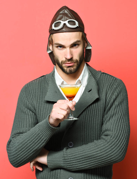 bearded pilot with cocktail in glass - Photo, image