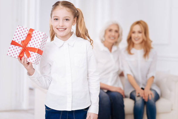 Pretty little smiling girl holding present - Photo, Image