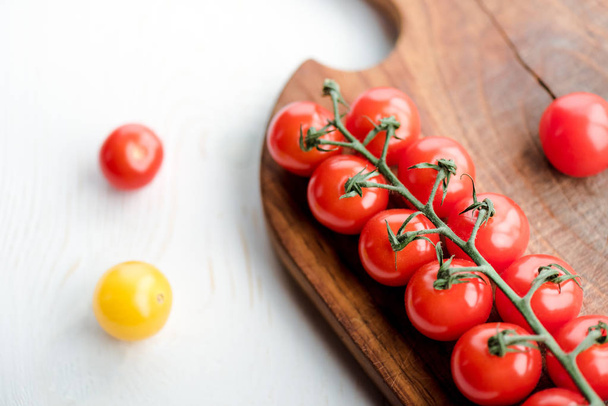 Tomatoes and cutting board    - Фото, изображение