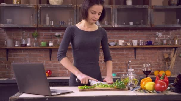 Young lady cooks healthy food - Filmati, video