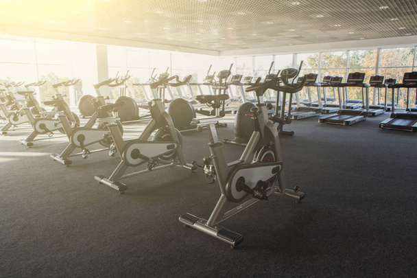 Modern gym interior with equipment, fitness exercise bikes - Photo, Image