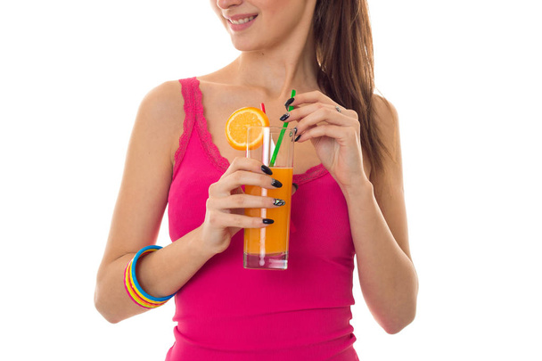 lovely young girl in pink shirt drink orange cocktail and smiling isolated on white background - Photo, image