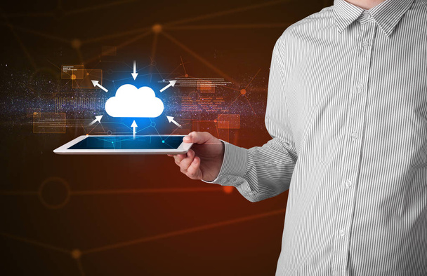 Businessman holding tablet with cloud icon - Foto, afbeelding