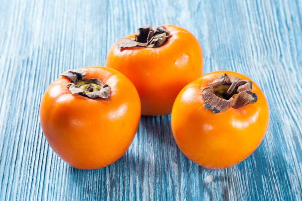 Persimmons on table - Photo, image