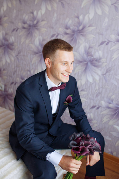 Gorgeous smiling groom. andsome groom at wedding tuxedo smiling and waiting for bride.Elegant man in black costume and bow-tie. - Φωτογραφία, εικόνα
