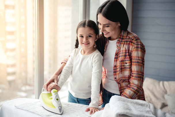 Mom and daughter ironing - Foto, imagen