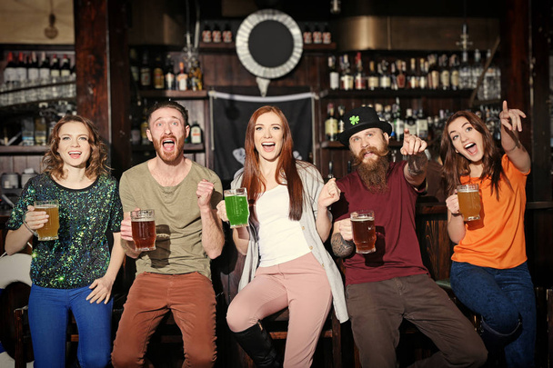 People celebrating Saint Patrick's Day in pub - Фото, зображення
