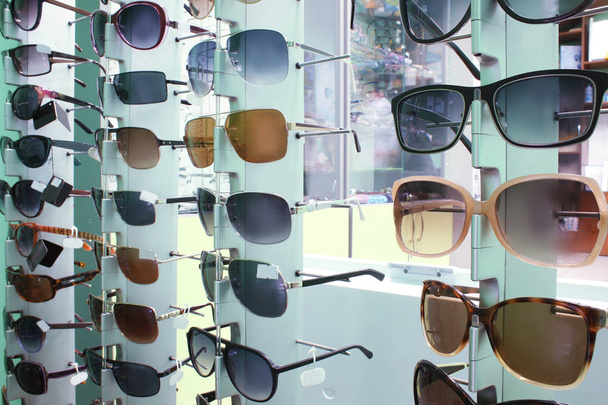 Showcase with different sunglasses - Fotó, kép
