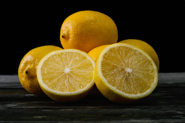 Fresh lemons on an old wooden table.  - Фото, изображение