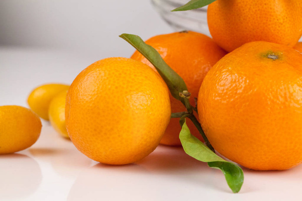 Surface covered with multiple ripe fresh juicy tangerines, compositionon the white background - Фото, изображение
