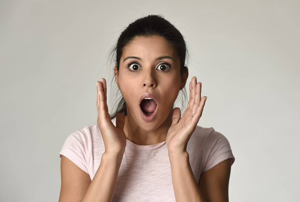 young beautiful surprised woman amazed in shock and surprise with mouth big opened - 写真・画像