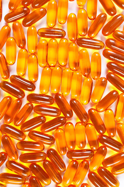 Orange medical capsules as background, health care concept - Fotografie, Obrázek