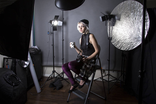 Hipster Photographer Drinking Coffee in a Studio - Photo, Image