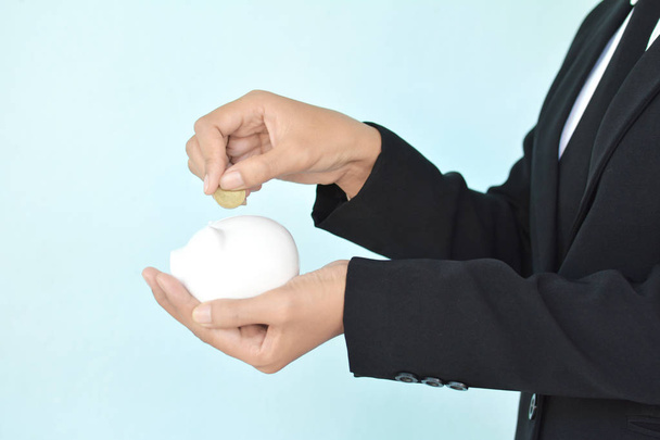 Businesswomen holding coin and white piggy bank  - Foto, Imagem