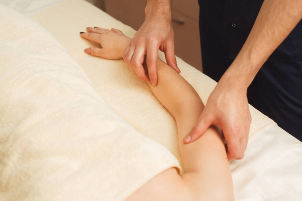 Masseur massaging woman arm free space - Valokuva, kuva