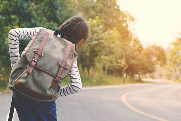 Happy Asian girl backpack in the road and forest background - Photo, Image