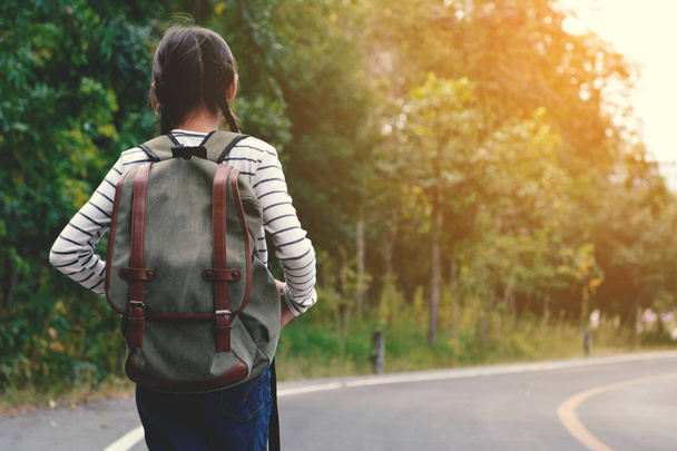 Happy Asian girl backpack in the road and forest background - Photo, Image