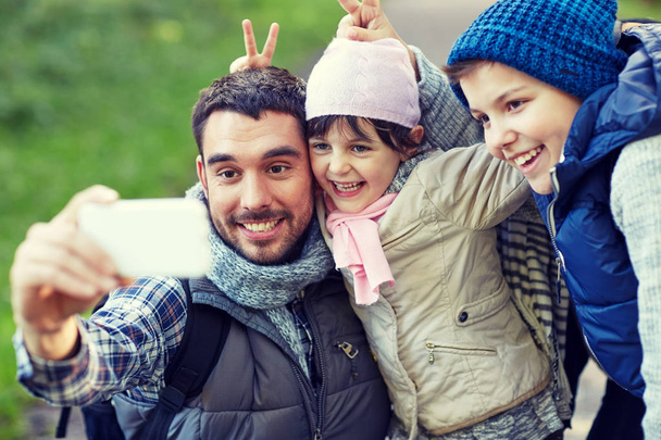 family taking selfie with smartphone outdoors - Zdjęcie, obraz