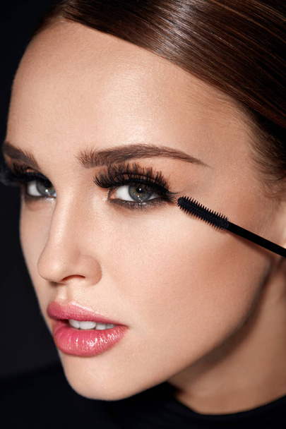 Long Black Eyelashes. Woman With Makeup Applying Cosmetics - Foto, afbeelding