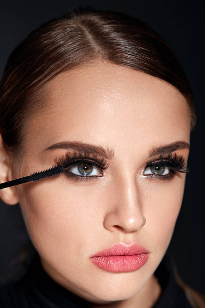 Long Black Eyelashes. Woman With Makeup Applying Cosmetics - Фото, изображение