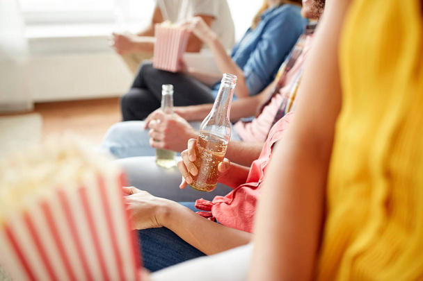 close up of friends with popcorn and beer at home - Fotoğraf, Görsel